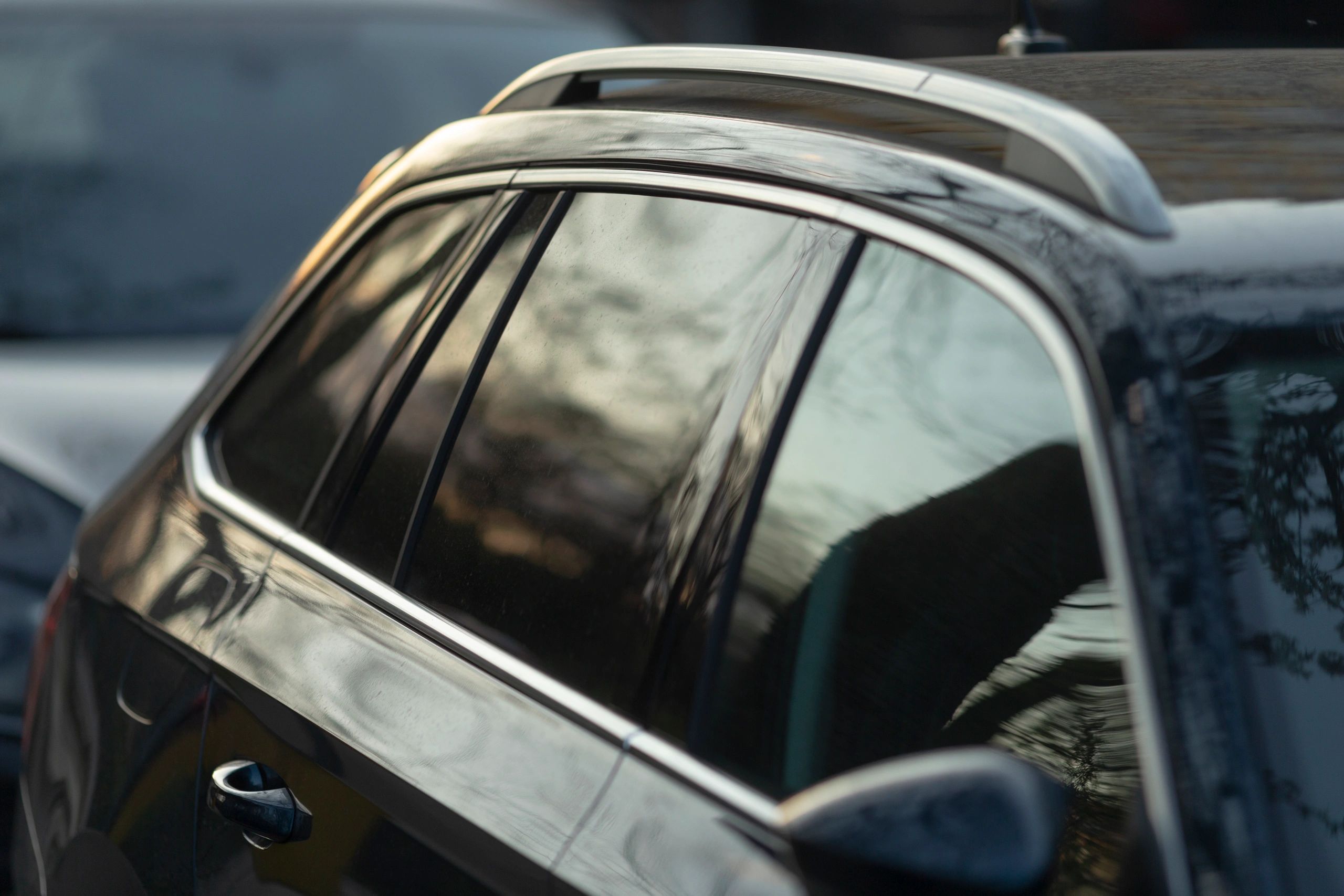 Tinted car window with reflections